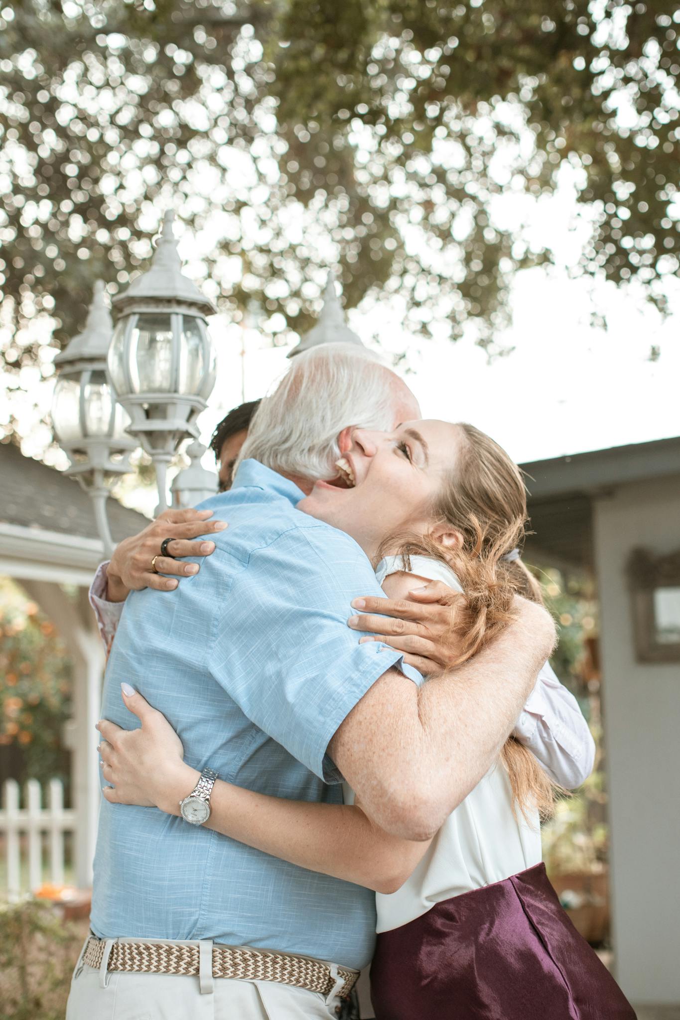 Heartwarming moment of a family embracing outdoors with joy and affection.